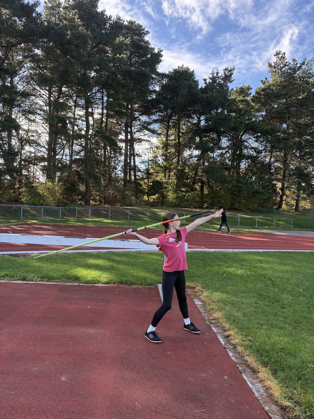 A young athlete at full extension in the javelin